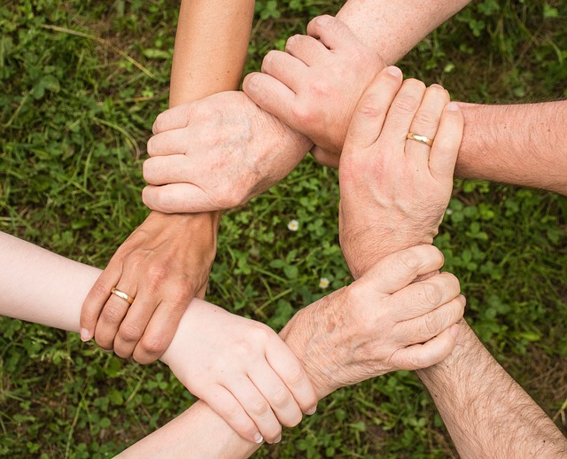 People interacting in a community setting, representing engagement and evolution.