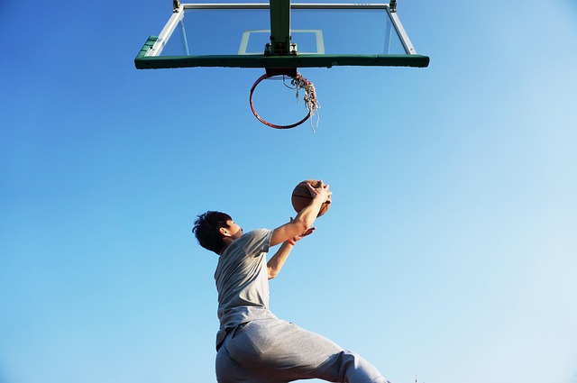 Dynamic basketball player mid-air, illustrating intense action and focus.